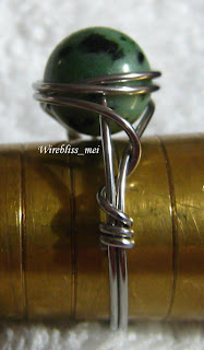 side view of wire wrapped ring with green stone (no name)