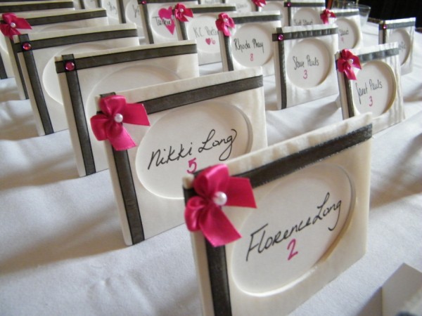 The pink ribbons on the name cards which were fabriccovered picture frames 