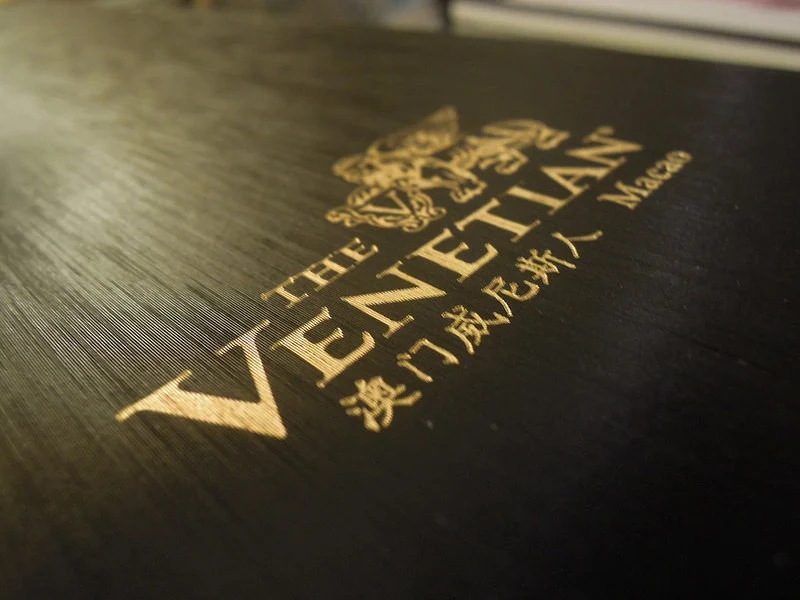 A leather folio containing the name of The Venetian Macao Resort Hotel