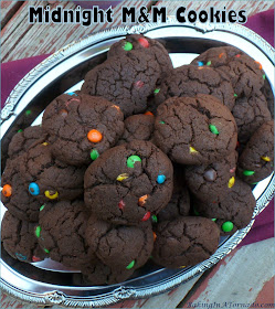 Lower in fat than most cookies, Midnight M&M Cookies are still full of chocolate flavor. Mini M&Ms add a crunch in every bite. | Recipe developed by www.BakingInATornado.com | #recipe #chocolate