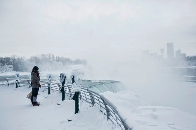 The mist coming off the falls is thick any time of year. However, in the winter, you can see the buildup as it freezes. Check out the binoculars! - Bizarrely Low Temperatures Transformed Niagara Falls Into A Frozen Wonderland