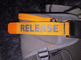 Bright orange fabric strip with grey letters "RELEASE"