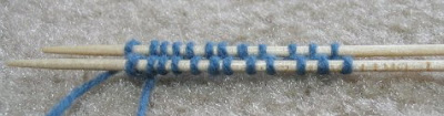 Stitches alternately transferred to 2 needles.