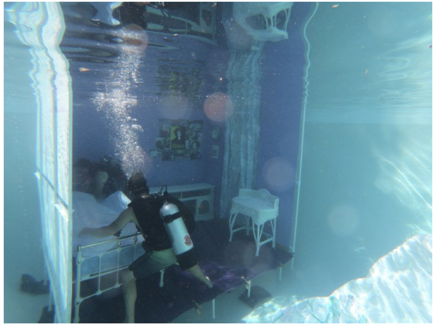man under water scuba gear setting up a water photoshoot