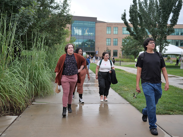 Students walking outside on SLCC's Taylorsville Redwood Campus on the first day of Fall Semester 2023