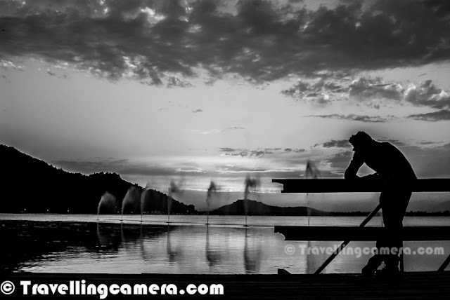 Dal Lake is beautiful lake in Srinagar city of Jammu & Kashmir State. Shrinagar is also know as summer capital of Jammu and Kashmir State of India. The urban lake, which is the second largest in the state, is integral to tourism and recreation in Kashmir and is nicknamed the 'Jewel in the crown of Kashmir' or 'Srinagar's Jewel'. The lake is also an important source for commercial operations in fishing and water plant harvesting. Let's check out this Photo Journey to know more about Dal Lake in this beautiful city of Kashmir !Last month I was in Shrinagar for 3rd Mughal Rally by Himalayan Motorsports and all these photographs are shot during one of the evenings, when we were relatively free and could spend some time around Nagin & Dal Lake. Although one of the mornings we also went for Shikara Ride through Old Kashmir and markets around lake. We shall also be sharing same photographs in colors soon, as sunset colors were really magical...Dal lake is quite popular as a visitor attraction and a summer resort for tourists from various parts of India and other countries. Fisheries and the harvesting of food and fodder plants are also important on Dal Lake. Weeds from the lake are extracted and converted into compost for the gardens. It also serves as a flood lung of the Jhelum River. Swimming, boating, snow skiing and canoeing are amongst some of the water sports activities practiced on the lake.Various Houseboats can be seen around different Lakes in Shrinagar. Houseboats and the Dal Lake are widely associated with Srinigar and are nicknamed 'floating palaces', built according to British customs. The houseboats are generally made from local cedar-wood and are graded in a similar fashion to hotels according to level of comfort. Many of them have lavishly furnished rooms, with verandas and a terrace to serve as a sun-deck or to serve evening cocktails. They are mainly moored along the western periphery of the lake, close to the lakeside boulevard in the vicinity of the Dal gate and on small islands in the lake. They are anchored individually, with interconnecting bridges providing access from one boat to the other. The kitchen-boat is annexed to the main houseboat, which also serves as residence of the boat-keeper and his family(Courtesy - http://en.wikipedia.org/wiki/Dal_Lake)Dal Lake is in the heart of Srinagar city and is well connected by road & air links. The nearest airport, which connects with other major cities in the country, is about 7 kilometres away at Badgam. The nearest railway station is 300 kilometres away at Jammu. The National Highway NH1A connects the Kashmir valley with rest of the countrDal lake covers an area of around 18 square kilometres and is part of a natural wetland which covers around 21 square kms, including its floating gardens. The floating gardens, known as 'Rad' in Kashmiri, blossom with lotus flowers during July and AugustThe wetland is divided by causeways into four basins - Gagribal, Lokut Dal, Bod Dal and Nagin. Nagin is also considered as separate lake and we stayed Centaur Hotel which is near to Nagin Lake only. Lokut-dal and Bod-dal each have an island in the centre, known as Rup Lank  and Sona Lank respectively.Shoreline of the Dal Lake is about 15.5 kilometres and encompassed by a boulevard lined with Mughal era gardens, parks, houseboats and hotels. Scenic views of Dal lake can be witnessed from Mughal gardens, such as Shalimar Bagh and Nishat Bagh built during the reign of Mughal Emperor Jahangir and from houseboats cruising along the lake in the colourful shikaras.Dal lake has numerous sites and places of interest, many of which are important to the cultural heritage of Srinigar. Aside from the Shalimar Bagh and Nishat Bagh, some of the other places frequented by tourists are the Shankaracharya temple, the Hari Parbat, the Nagin Lake, the Chashme Shahi, the Hazratbal Shrine, the famous Kashmir houseboats and the Shikara (boat) called the Gandola of Kashmir.Shikaras provide a water taxi service available to see the sights in the Dal Lake and to approach the houseboats moored on the lake periphery.Dal Lake has become an icon of the Kashmir tourism industry and almost every tourist dream of having a Shikara ride in this lake and stay at least for one night in House-Boats. A Himalayan urban lake which has five basins and a number of channels that are well linked with each other. There are plenty of fishes in Dal Lake and fishery is the second largest industry of the region centered on the lake.The sparkling quiet waters of Dal surrounded by snow-capped mountains on its three sides, undoubtedly mark it as one of the most beautiful lakes of India. It is also the second largest lake in the State of Jammu and Kashmir with numerous gardens and orchards all along its shores. Houseboats form an indelible part of the scenery of the Dal Lake that are always ready to take tourists to a romantic and peaceful ride of the lake and soothe their nerves as the houseboat floats over the slightly rippling waters. They also offer some of the most exotic views of the splendid scenery of the Dal Lake. 