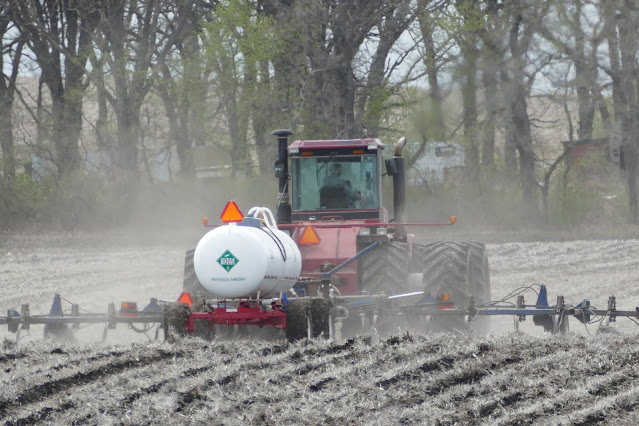 Tractor distributing fertilizer