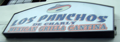 Los Panchos white plastic sign back lit by florescent lights (off)