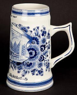 A commemorative Heineken beer tankard in white and blue Delft ceramic style