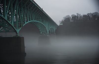 A bridge over a misty river.