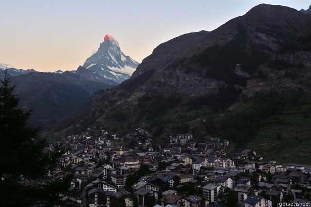 Shooting the Matterhorn with Zermatt at dawn. First rays of the morning sun lighting up the tip of the Matterhorn.