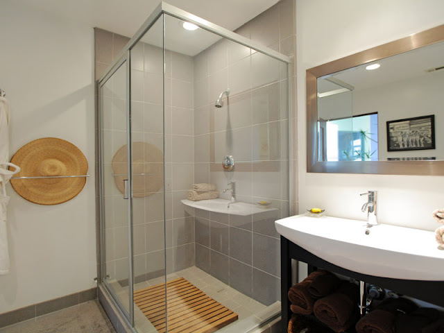 Photo of modern bathroom interiors showing shower cabin and the sink