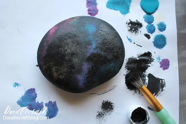 Painting a galaxy with stars and planets and the moon on a rock with hand lettered text diy instructions