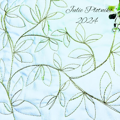 Stitching of twigs and leaves in green thread on white