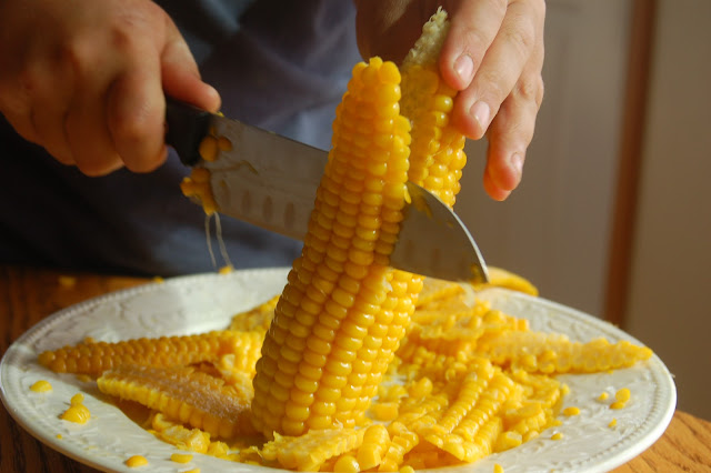 To cut corn from the cob, hold cob upright, resting one end on a ...