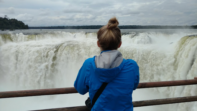 a girl gazes at Devil's Throat, Iguazu