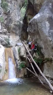 climbing on the side of a waterfall