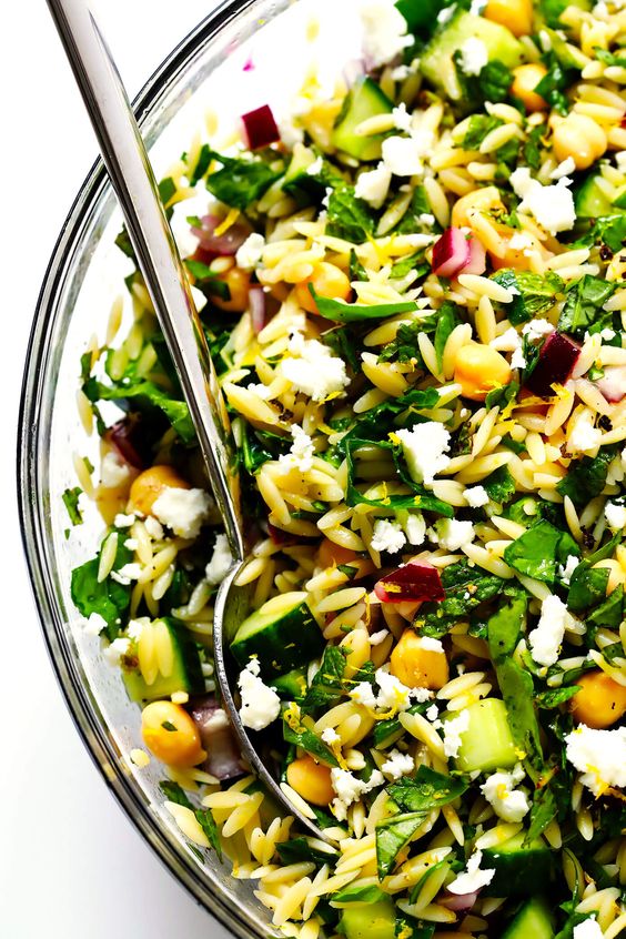 LOVE this Herb-Lovers Lemony Orzo Salad recipe! It's filled with lots of fresh basil, mint, cucumber, red onion, chickpeas, and feta. It's naturally vegetarian and vegan (if you nix the cheese). It's perfect for summer dinners and potlucks, and always a crowd fave! | Gimme Some Oven #pastasalad #orzo #potluck #vegetarian #vegan