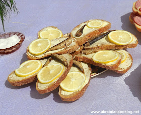 Open sandwiches with sprats on Ukrainian festive table