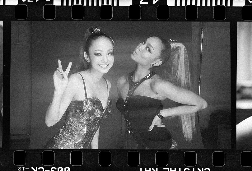 A black and white photo of Namie Amuro and Crystal Kay, on set for the cover shoot for their song “Revolution”.
