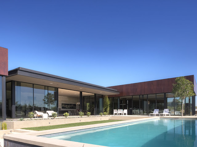 Photo of modern luxury house in Hollywood as seen from the pool area during the day