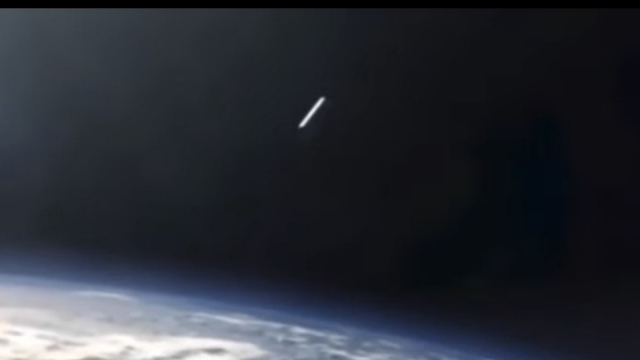 Cigar shaped UFO in space.