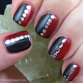 Half red, half black nail art with silver chrome dotting.