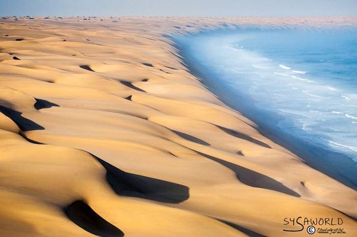 The Southern Namib desert is home to some of the tallest and most spectacular dunes of the world, ranging in color from pink to vivid orange. These dunes continue right to the edge of the Atlantic Ocean. The cold waters of the sea brushing against the dunes of the Namib desert is one of the most surreal sights.