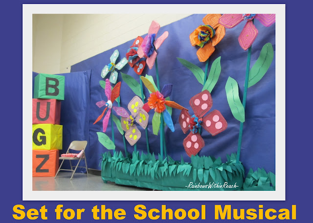 photo of: set design for elementary school musical, over-sized flower backdrop