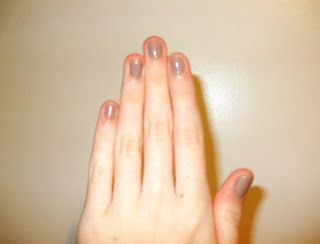 white hand with nude painted short nails