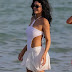 Kylie Jenner flaunts her hourglass curves in a white swimsuit as she joins her bikini-clad sister Kendall  in the ocean at beach club in St Tropez