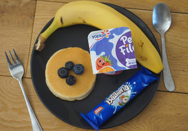 image shows a flat lay of a variety of foods on a black plate