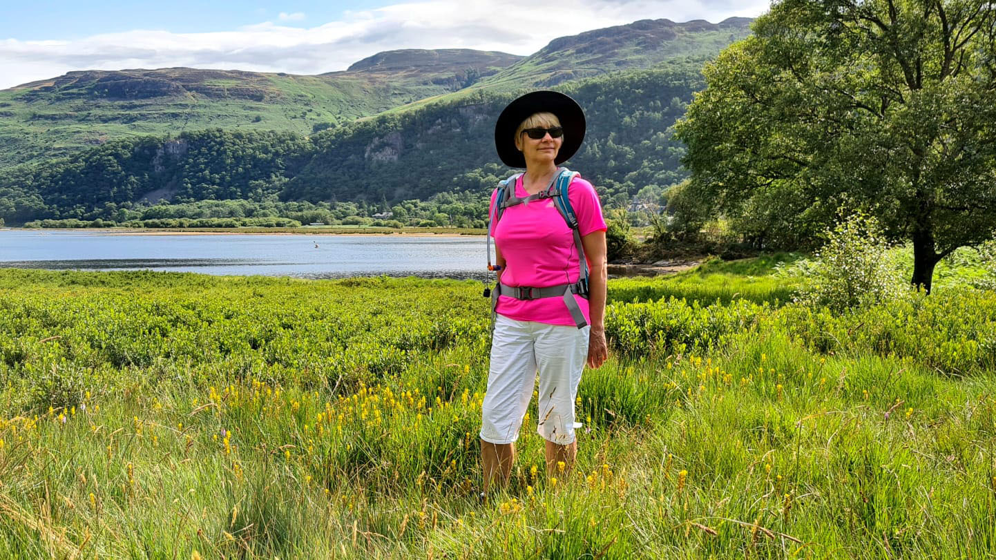 Over 50s blogger Gail Hanlon walking in the meadows alongside Derwentwater in the Lake District