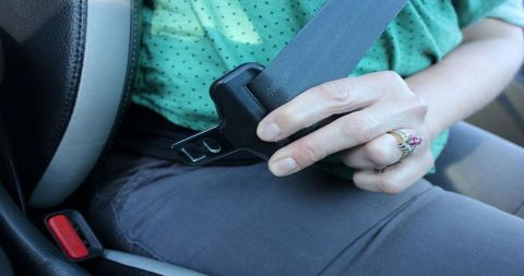 Which automobile manufacturer was the first to offer seat belts as an option?
