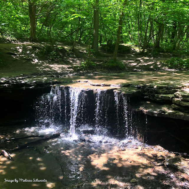 The gentle trickle of the waterfall at Platte River State Park crafts a moment of serenity.