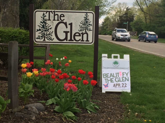 A Glen entry sign on Dublin Road, next to a fold-up sign advertising The Glen's Beautify The Glen event on April 22.