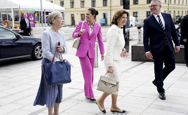 Silvia and Victoria attended the opening of H22 City Expo. Crown Princess Victoria wore a one button blazer suit pink fuchsia