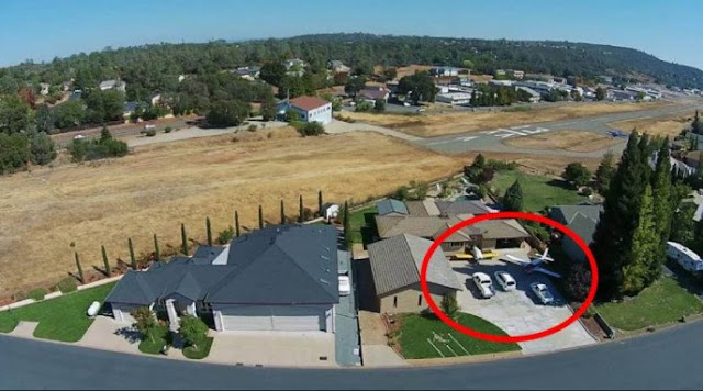 Cars are parked alongside planes in in Cameron Park, California