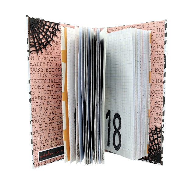 31 days of Halloween movie watchlist notebook insert and inner chipboard album covers embellished with chipboard spiderwebs.