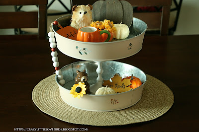 Completed tiered tray with fall decorations on dining table