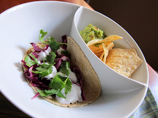 Mahimahi tacos in a bowl with  chips and guacamole