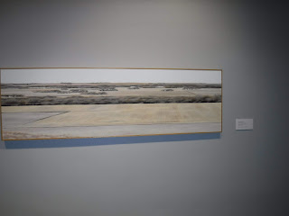 a digitally printed canvas art piece at the Sioux City Art Center depicts golden fields and green trees typical of an Iowa landscape