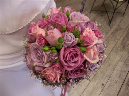 Beautifully romantic wedding bouquet made up of pink and purple roses