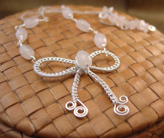 Sterling silver wire woven bow pendant adorned with rose quartz beads created by Vicky Brown of Shore Debris