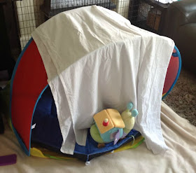 play tent covered with white sheet to make a den