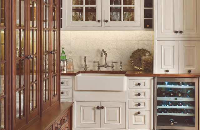 Vintage style kitchen with farmhouse sink and wood cabinets.