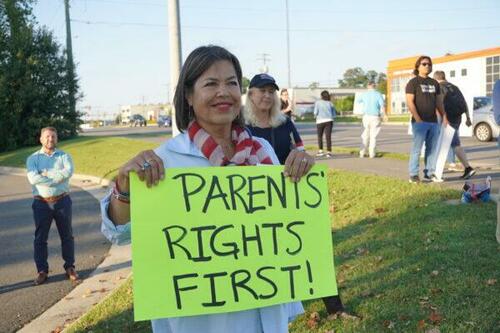 “Parents rights first”: Fairfax County resident Lin-Dai Kendall protests at a rally outside Luther Jackson Middle School before a Fairfax County Public Schools board meeting, in Falls Church, Va., on Sept. 15, 2022.
