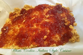 An old fashioned cookie bar filled with raspberry jam and has an oatmeal crust