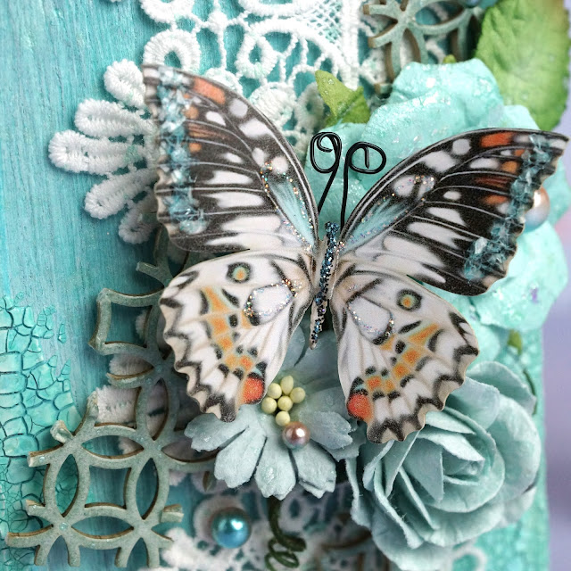 mixed media project made with Reneabouqets butterfly, chipboard, beautiful beads pearls, lace, paper flowers; Tim Holtz Distress Spray Stain salvaged patina and speckled egg, Distress Oxide Spray, Distress Glaze weathered wood; Scrapbook.com Pops of Color seafoam; Prima Marketing flower