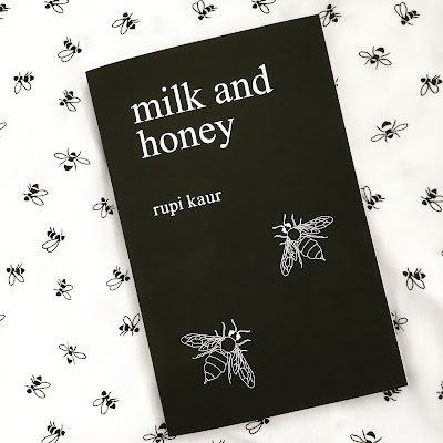 A black book cover with two bees on it. The text reads 'milk and honey' and it is written by rupi kaur.